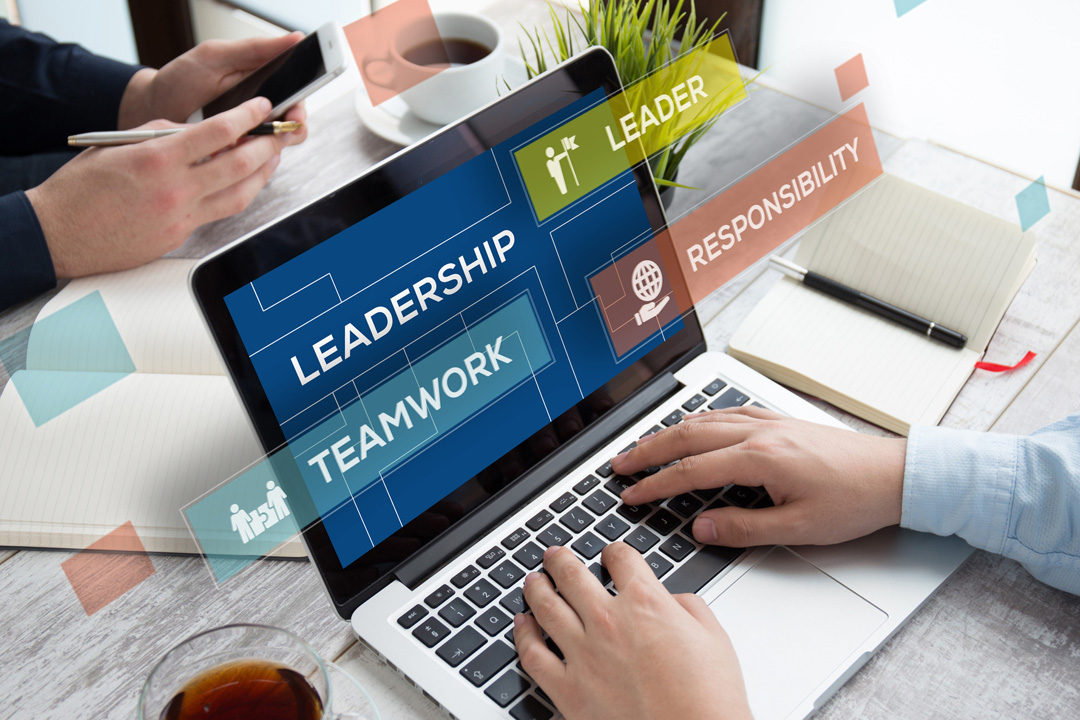 Hands typing on a laptop with graphic overlays highlighting leadership, teamwork, and responsibility concepts